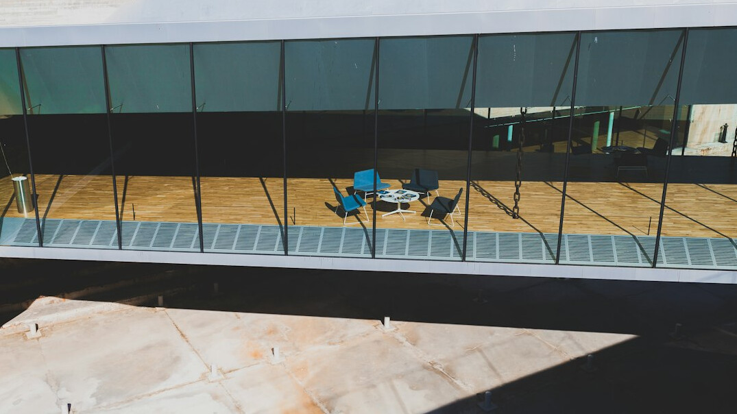 Aerial view of an open plan newsroom office with desks and computer monitors